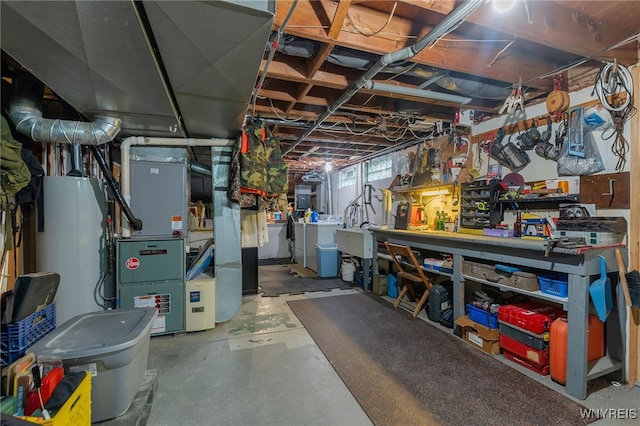 112 Creekview Dr, West Seneca, NY 14224 - below grade area featuring water heater, separate washer and dryer, heating unit, and a workshop area