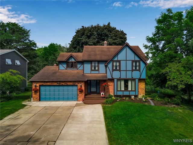 112 Creekview Dr, West Seneca, NY 14224 - tudor-style house featuring concrete driveway, a front yard, and brick siding