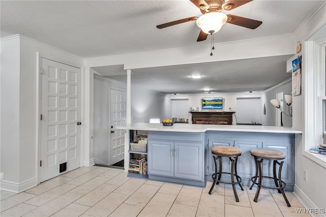 112 Creekview Dr, West Seneca, NY 14224 - kitchen featuring blue cabinetry, a peninsula, light countertops, crown molding, and ceiling fan