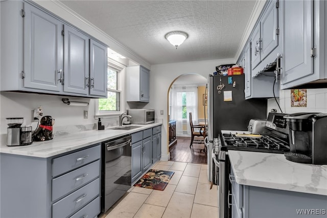 112 Creekview Dr, West Seneca, NY 14224 - kitchen featuring stainless steel range with gas cooktop, dishwasher, gray cabinets, arched walkways, and healthy amount of natural light