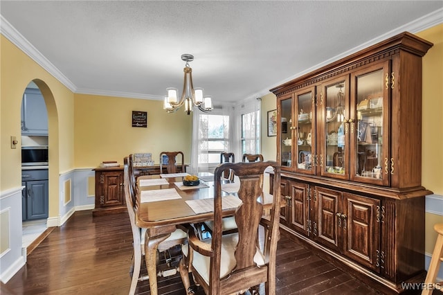 112 Creekview Dr, West Seneca, NY 14224 - dining room featuring crown molding, a chandelier, dark wood-style floors, and arched walkways