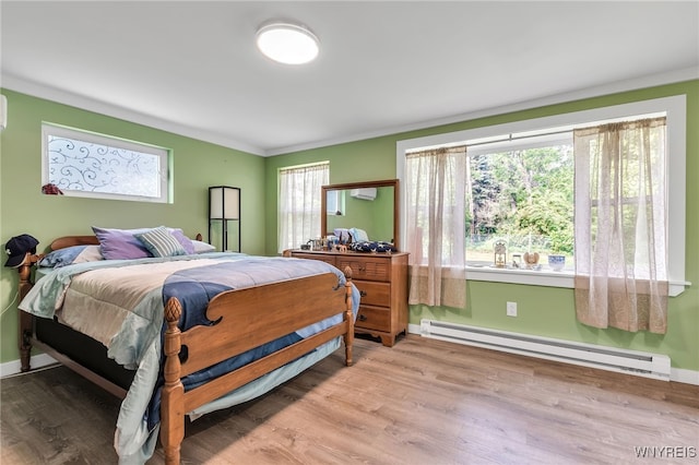 112 Creekview Dr, West Seneca, NY 14224 - bedroom with a baseboard heating unit, light wood finished floors, and ornamental molding