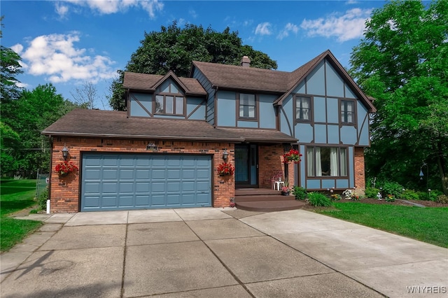 112 Creekview Dr, West Seneca, NY 14224 - tudor-style house featuring brick siding, concrete driveway, roof with shingles, and a chimney