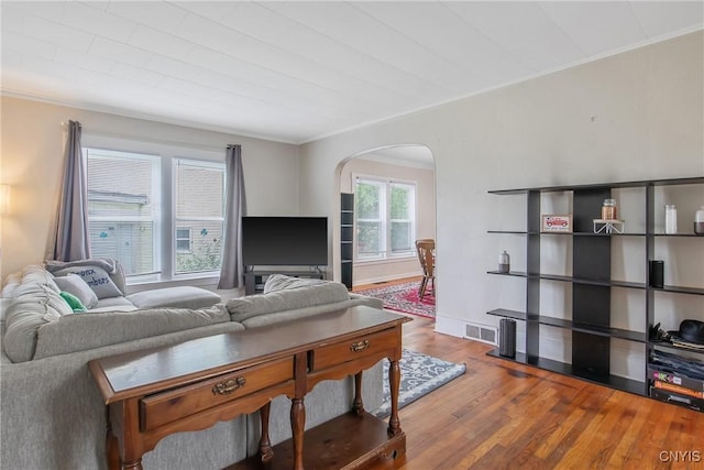 505 Tompkins St, Syracuse, NY 13204 - living room with arched walkways, wood finished floors, and ornamental molding