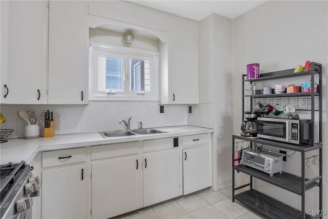 505 Tompkins St, Syracuse, NY 13204 - kitchen featuring appliances with stainless steel finishes, light countertops, and white cabinetry