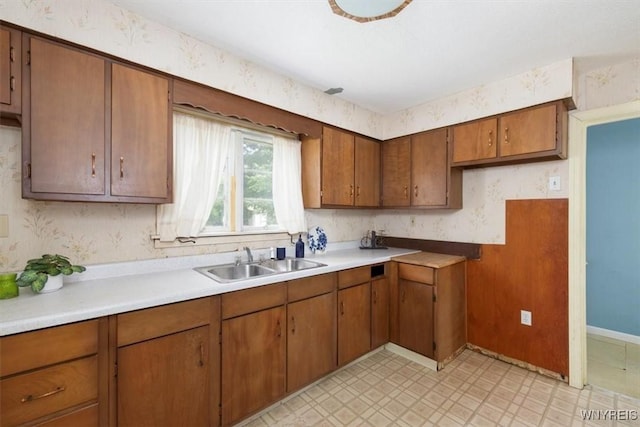 5156 Fairgrounds Rd, Hamburg, NY 14075 - kitchen with brown cabinetry, wallpapered walls, light floors, and light countertops