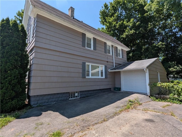883 Brown Rd, Irondequoit, NY 14622 - view of front of property with a chimney, an attached garage, and driveway