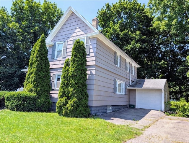 883 Brown Rd, Irondequoit, NY 14622 - view of home's exterior featuring a chimney, concrete driveway, and a yard