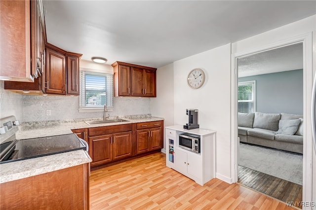 445 75th St, Niagara Falls, NY 14304 - kitchen with appliances with stainless steel finishes, light wood-style floors, and plenty of natural light