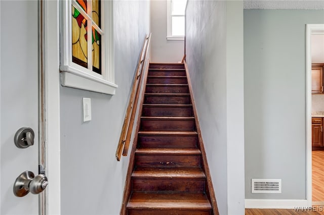 445 75th St, Niagara Falls, NY 14304 - staircase featuring wood finished floors