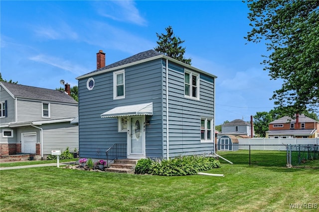 445 75th St, Niagara Falls, NY 14304 - view of front of property with a chimney and a storage shed