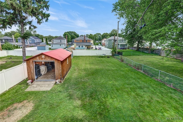 445 75th St, Niagara Falls, NY 14304 - fenced backyard featuring an outdoor structure and a residential view