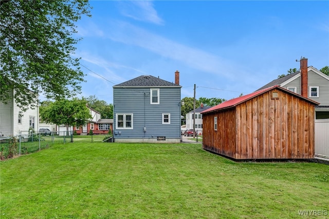 445 75th St, Niagara Falls, NY 14304 - back of house featuring an outdoor structure and a chimney