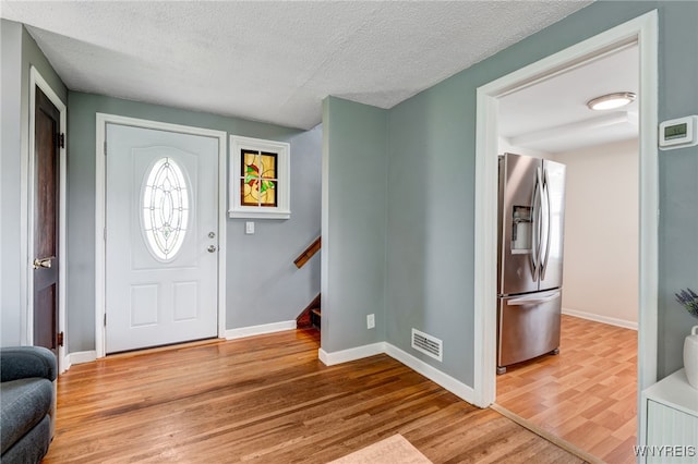 445 75th St, Niagara Falls, NY 14304 - entryway featuring wood finished floors and a textured ceiling