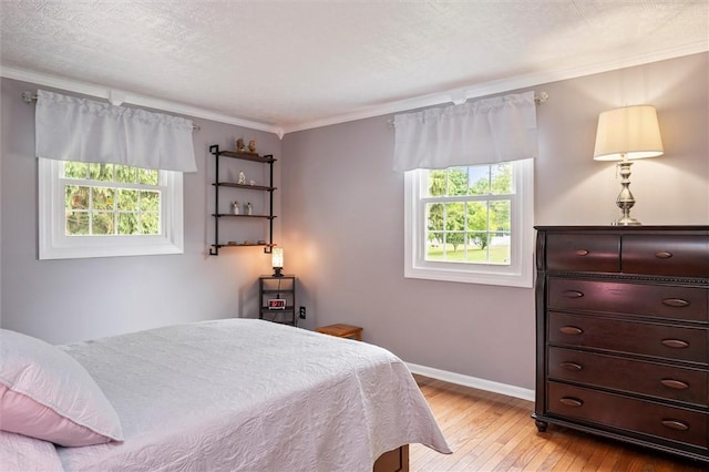 798 Hawthorne Pl, Webster, NY 14580 - bedroom featuring multiple windows, light wood finished floors, and crown molding