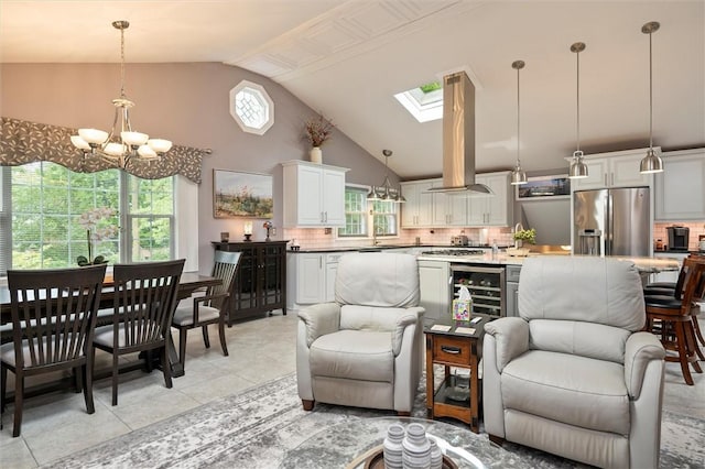 798 Hawthorne Pl, Webster, NY 14580 - living room with lofted ceiling, a chandelier, a skylight, light tile patterned flooring, and beverage cooler
