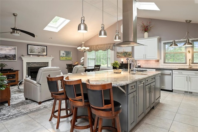 798 Hawthorne Pl, Webster, NY 14580 - kitchen featuring a skylight, stainless steel dishwasher, light tile patterned flooring, island exhaust hood, and vaulted ceiling