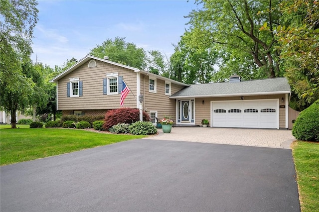 798 Hawthorne Pl, Webster, NY 14580 - tri-level home with driveway, a garage, a front yard, and a chimney
