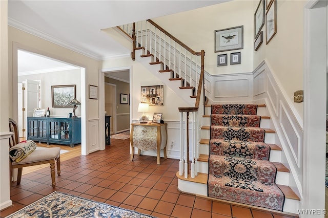 29 Cherry Tree Ln, Orchard Park, NY 14127 - staircase featuring a decorative wall, ornamental molding, wainscoting, and tile patterned floors