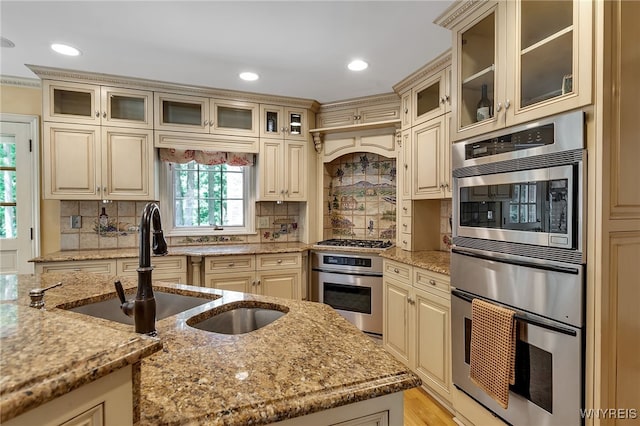 29 Cherry Tree Ln, Orchard Park, NY 14127 - kitchen with stainless steel appliances, cream cabinetry, light stone counters, a warming drawer, and recessed lighting