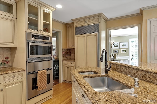29 Cherry Tree Ln, Orchard Park, NY 14127 - kitchen featuring built in appliances, cream cabinets, a warming drawer, light wood-style floors, and crown molding