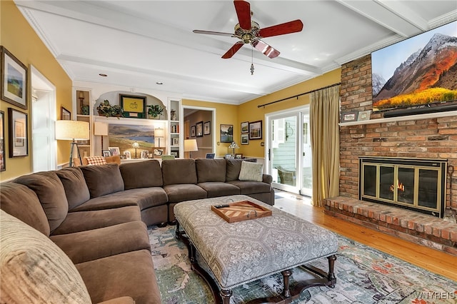 29 Cherry Tree Ln, Orchard Park, NY 14127 - living room with beamed ceiling, wood finished floors, a ceiling fan, a brick fireplace, and ornamental molding