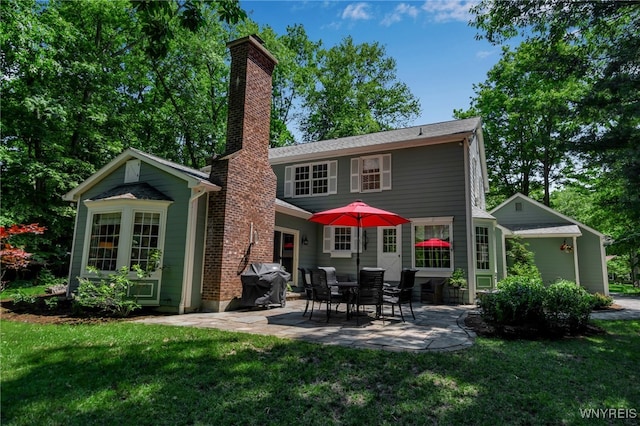 29 Cherry Tree Ln, Orchard Park, NY 14127 - rear view of property featuring a chimney, a yard, and a patio