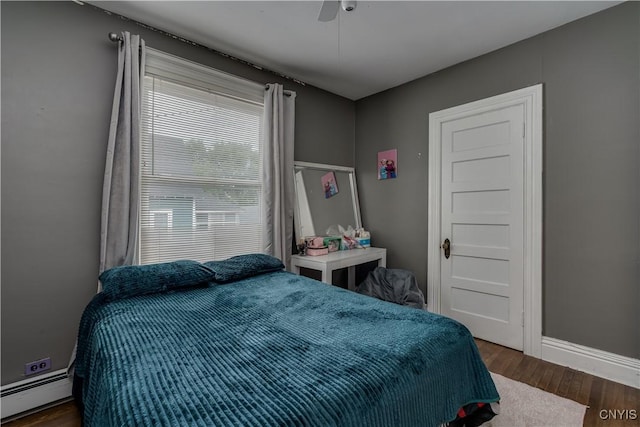 210 N James St, Wilna, NY 13619 - bedroom featuring a baseboard radiator, wood finished floors, and ceiling fan
