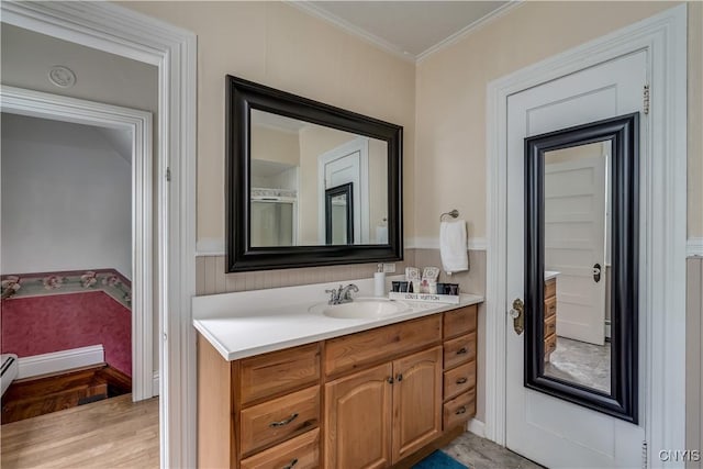 210 N James St, Wilna, NY 13619 - bathroom featuring vanity, crown molding, wainscoting, and wood finished floors