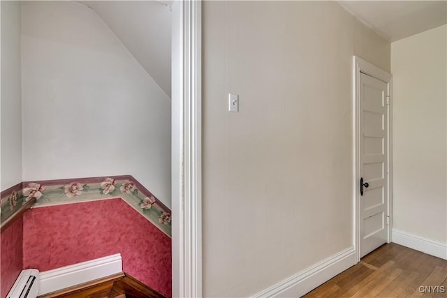 210 N James St, Wilna, NY 13619 - bathroom with baseboard heating, lofted ceiling, and wood finished floors