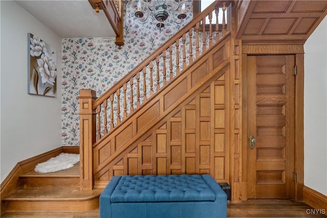 210 N James St, Wilna, NY 13619 - staircase featuring a chandelier, wood finished floors, and wallpapered walls