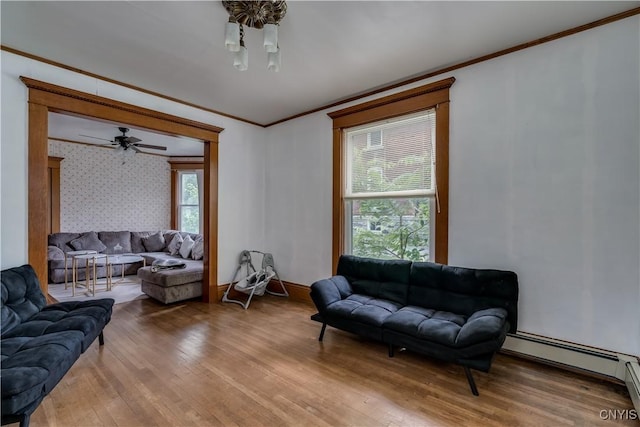 210 N James St, Wilna, NY 13619 - living room with ornamental molding, wood finished floors, healthy amount of natural light, a baseboard heating unit, and a ceiling fan