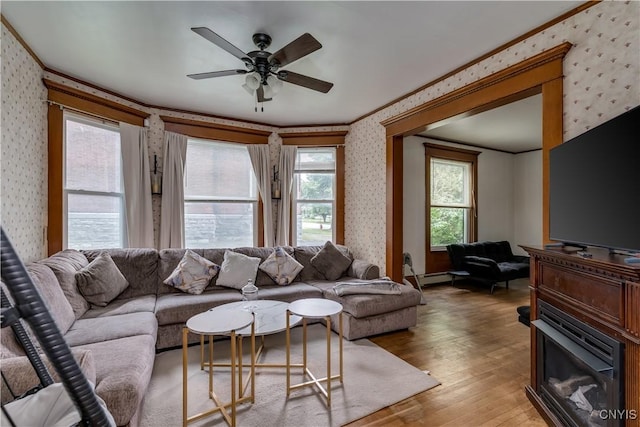 210 N James St, Wilna, NY 13619 - living room with wallpapered walls, crown molding, light wood-style flooring, ceiling fan, and baseboard heating