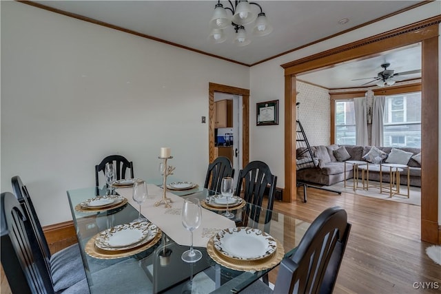 210 N James St, Wilna, NY 13619 - dining room featuring ornamental molding, wood finished floors, and a chandelier