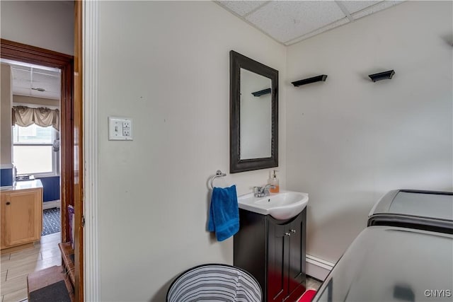 210 N James St, Wilna, NY 13619 - bathroom with a drop ceiling, vanity, washing machine and clothes dryer, and a baseboard radiator