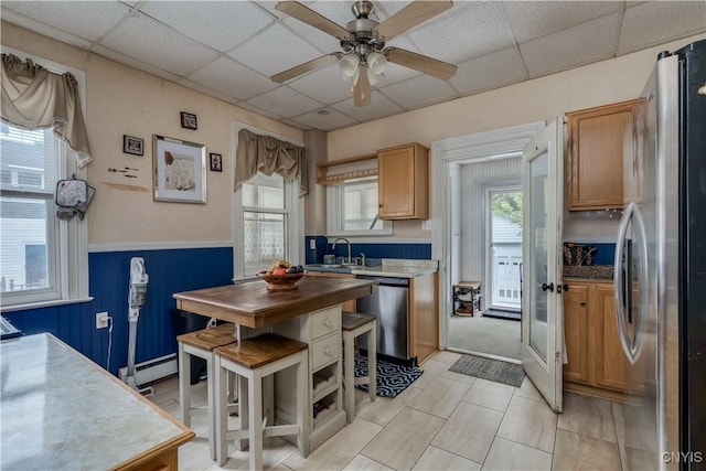 210 N James St, Wilna, NY 13619 - kitchen featuring stainless steel appliances, a drop ceiling, a ceiling fan, and wainscoting