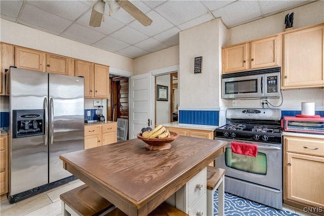 210 N James St, Wilna, NY 13619 - kitchen featuring stainless steel appliances, light brown cabinets, ceiling fan, a drop ceiling, and light countertops