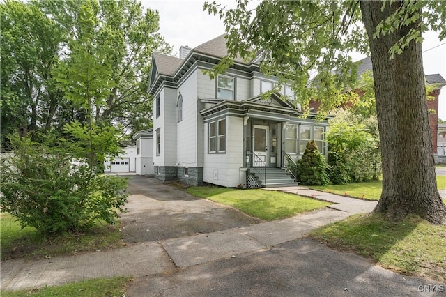 210 N James St, Wilna, NY 13619 - view of front of home featuring a shingled roof, a chimney, and a garage