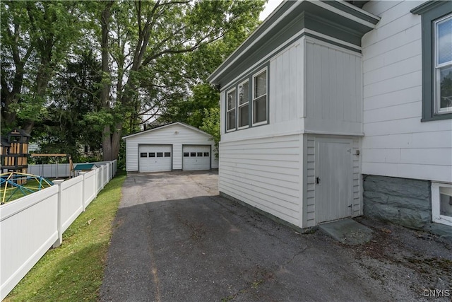 210 N James St, Wilna, NY 13619 - view of home's exterior with a garage and an outbuilding