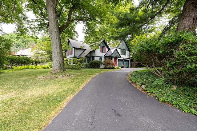 8 Oak Ln, Brighton, NY 14610 - english style home featuring a garage, a front yard, and asphalt driveway