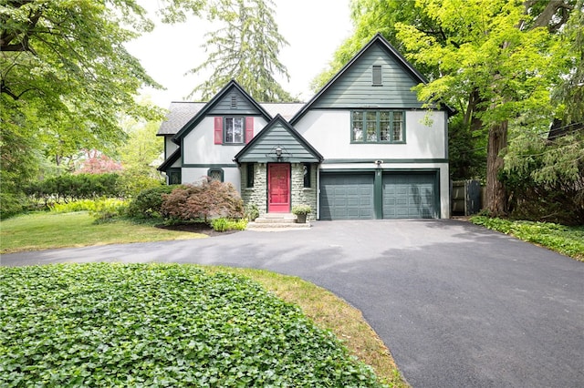 8 Oak Ln, Brighton, NY 14610 - tudor-style house featuring driveway, a garage, stone siding, and stucco siding