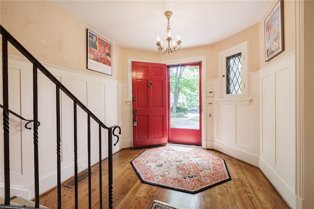 8 Oak Ln, Brighton, NY 14610 - entrance foyer with a decorative wall, a chandelier, wood finished floors, and wainscoting