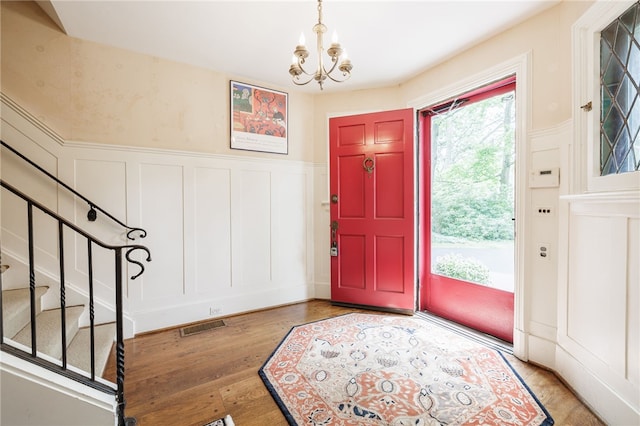 8 Oak Ln, Brighton, NY 14610 - foyer featuring a decorative wall, a chandelier, stairway, wood finished floors, and a wainscoted wall