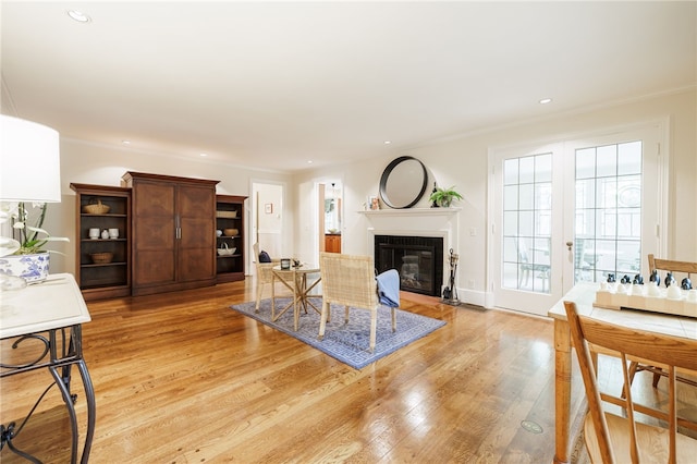 8 Oak Ln, Brighton, NY 14610 - living area featuring light wood-style flooring, a fireplace with flush hearth, recessed lighting, and crown molding