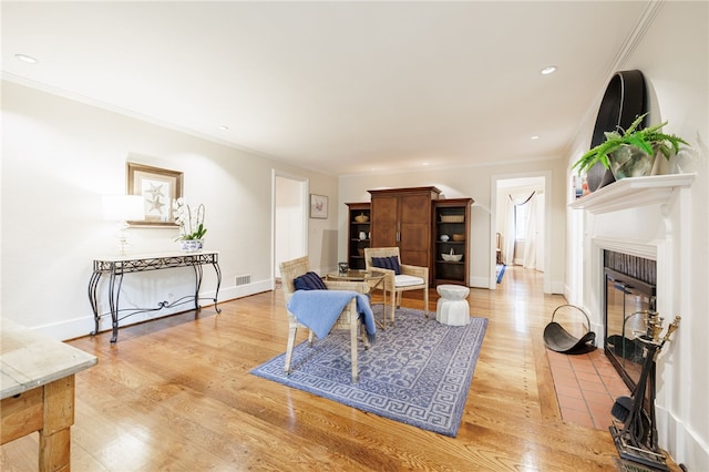 8 Oak Ln, Brighton, NY 14610 - living area with ornamental molding, a fireplace with flush hearth, light wood finished floors, and recessed lighting
