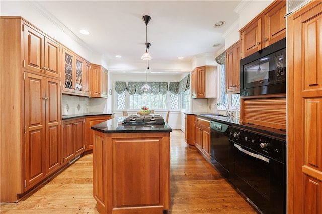 8 Oak Ln, Brighton, NY 14610 - kitchen featuring black appliances, ornamental molding, a kitchen island, light wood-style floors, and decorative light fixtures