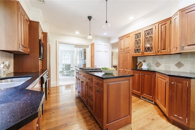 8 Oak Ln, Brighton, NY 14610 - kitchen featuring light wood-type flooring, tasteful backsplash, crown molding, dark stone counters, and hanging light fixtures