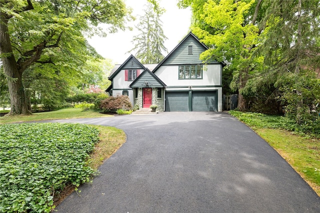 8 Oak Ln, Brighton, NY 14610 - english style home featuring asphalt driveway, stucco siding, and a garage