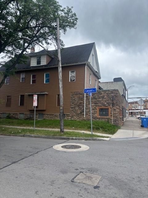 524-526 Dewey Ave, Rochester, NY 14613 - view of property exterior with stone siding and a chimney