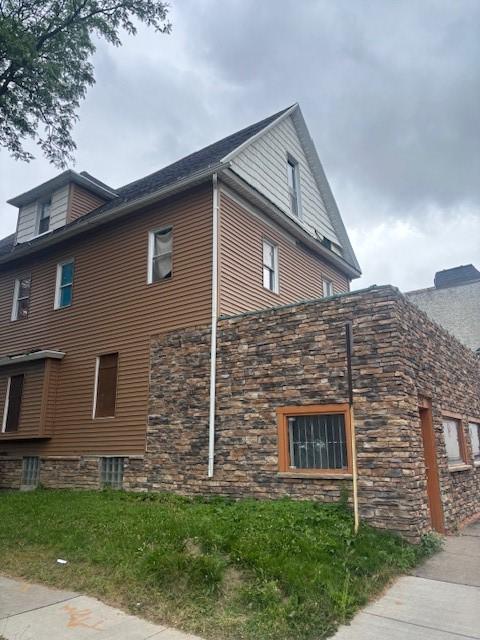 524-526 Dewey Ave, Rochester, NY 14613 - view of side of home featuring stone siding and a chimney